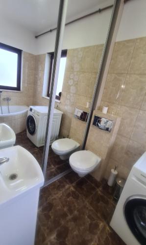 a bathroom with two toilets and a sink and a tub at Dom pod Wroclawiem19 in Domasław
