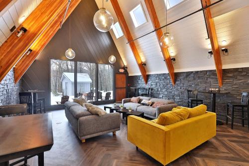 uma sala de estar com dois sofás e uma parede de pedra em The Birch Ridge- Blue Velvet Room #10 - Queen Suite in Killington, Vermont, Hot Tub, Lounge, home em Killington