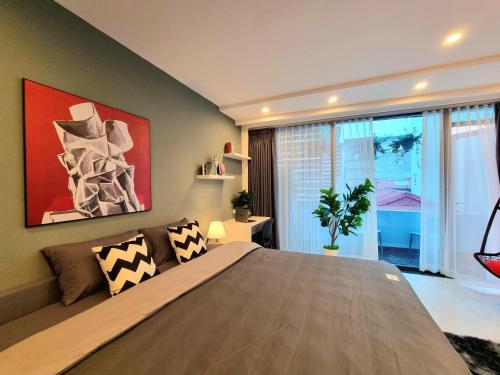 a bedroom with a large bed and a large window at LaHomestay Hồng Hà in Hanoi