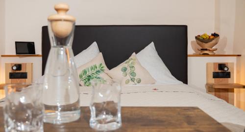 a bedroom with a bed and a table with a vase at Gasthof Rieder Stubn Hotel#Restaurant#Pinseria Lifestyle & Tradition in Ried im Oberinntal