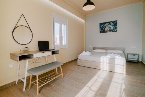 a bedroom with a bed and a desk with a mirror at Casa Gemma in Kos Town