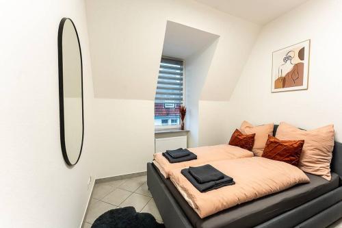 a bedroom with a bed with a black leather couch at Loft mit Billard-Tisch und PS4 in Wuppertal