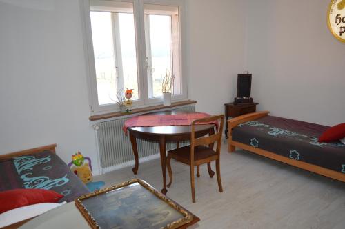 a bedroom with a table and a bed and a desk at Chez Thérèse et Marguerite in Kindwiller