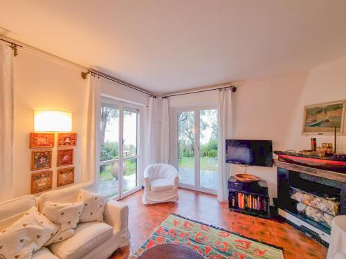 a living room with a white couch and a fireplace at L'uliveto di Santa con piscina in Santa Margherita Ligure