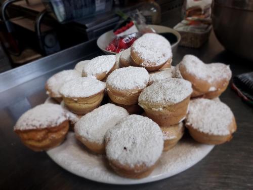 a plate of donuts with powdered sugar on it at Rezydencja Izabella in Wisła