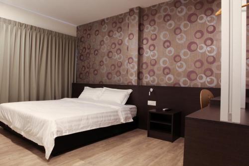 En eller flere senge i et værelse på Hotel Mezzo