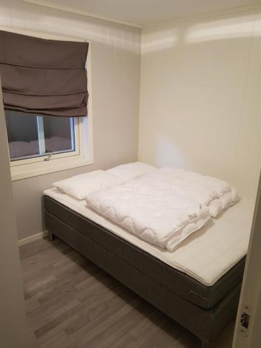 a large bed in a room with a window at Fjærland Våteviksvegen 17 in Bøyum