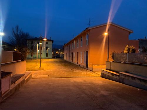 an empty street at night with a building at La Terrazza in San Giovanni Valdarno