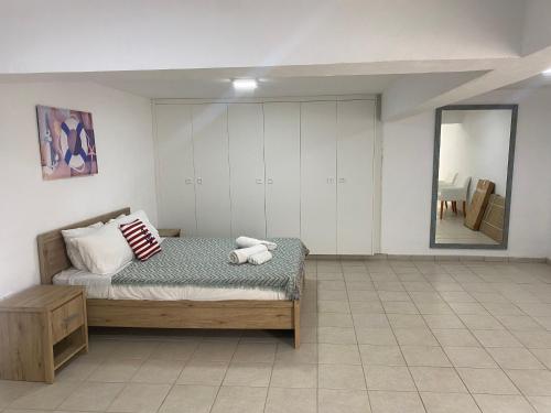 a bedroom with a bed with a teddy bear on it at Olive Tree Villa - Protaras in Protaras