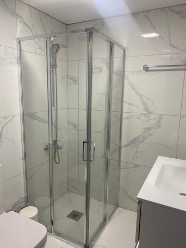 a shower with a glass door in a bathroom at Olive Tree Villa - Protaras in Protaras