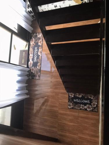 a hallway with a wooden floor with a welcome sign at Kembali coast resort A-house style in Caliclic