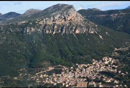 a view of a mountain with a town in front of it at Sa domu 'eccia in Urzulei