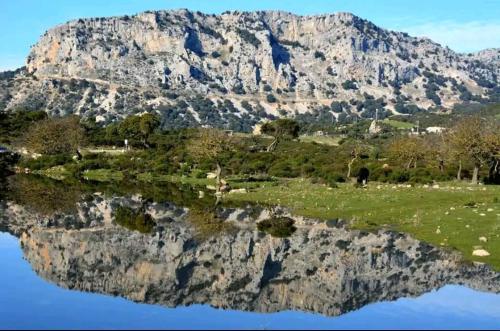 a reflection of a mountain in a body of water at Sa domu 'eccia in Urzulei