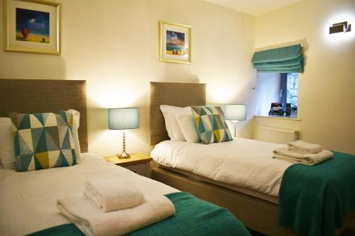 a bedroom with two beds with towels on them at Cannon Point BW7 in Fort Augustus