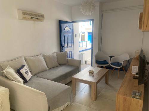 a living room with a couch and a table at Olive Tree Villa - Protaras in Protaras
