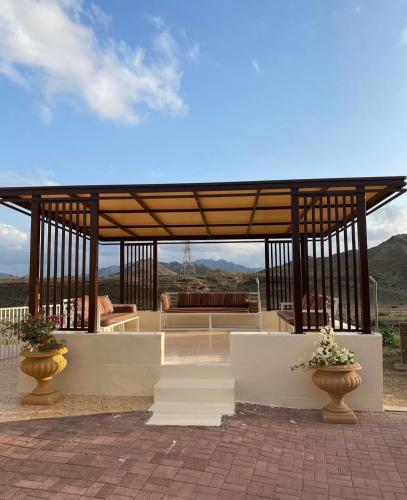 a gazebo with a couch and a table at Algor Farm in Qūr