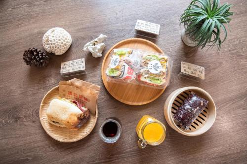 a table topped with plates of food and drinks at THEDAY B&B in Magong