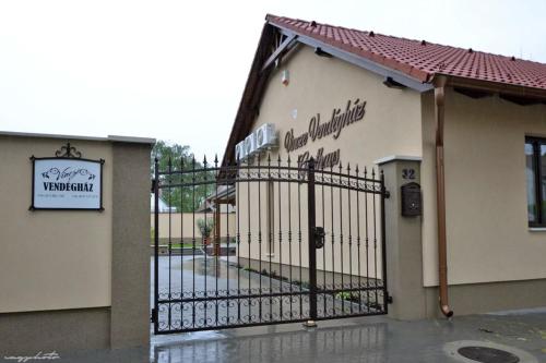 a gate to a building with a sign on it at Vincze Vendeghaz in Kiskunhalas