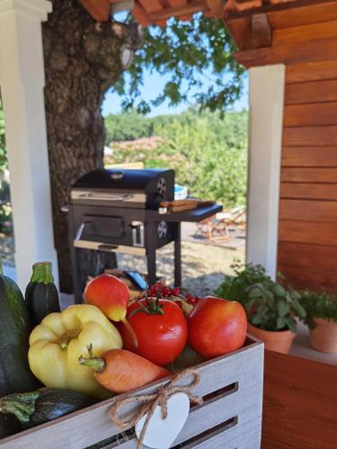 a wooden box filled with tomatoes and other fruits and vegetables at Apartment Luce in Pićan