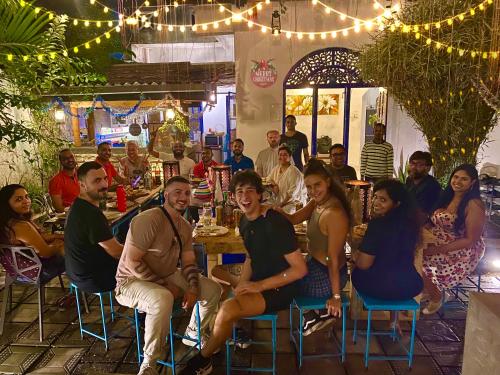 a group of people sitting at a table in a restaurant at Seconds Hostel - Colombo in Colombo