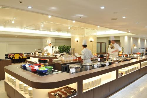 a group of chefs in a kitchen preparing food at Sunshine City Prince Hotel Ikebukuro Tokyo in Tokyo