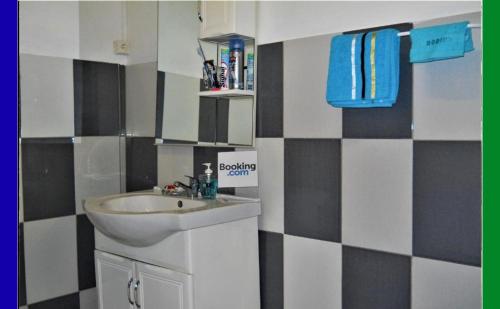 a bathroom with a sink and a mirror at Hostel des 3 sources in Sainte-Marie