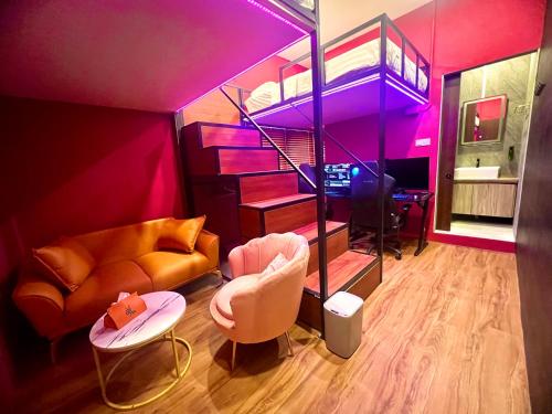 a living room with a couch and a loft at Arena eSports Hotel @ Bugis Village in Singapore