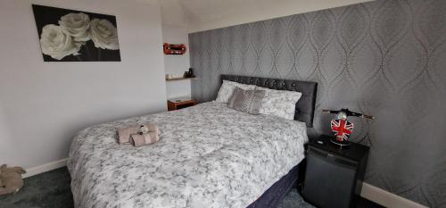 a bedroom with a large bed with a brown headboard at Cherrylee in Sandown