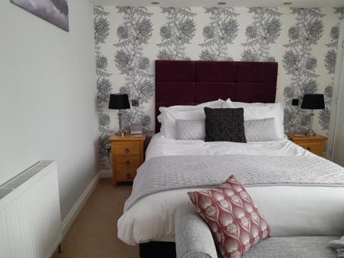 a bedroom with a large bed and two night stands at The Briarfields in Torquay