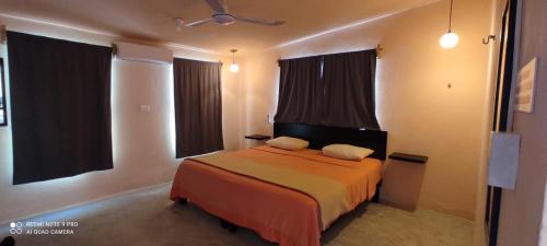 a bedroom with a bed with two pillows on it at LA CHOZITA DEL MAR in Celestún