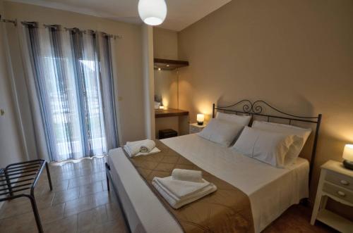 a bedroom with a large bed with towels on it at Astacos Studios in Paleokastritsa
