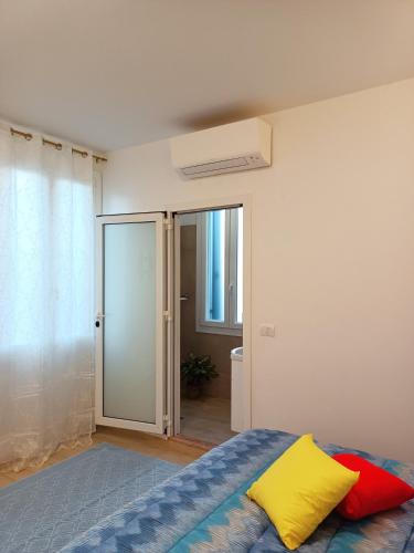 a bedroom with a bed and a sliding glass door at Arcobaleno Rooms Mestre-Venezia in Mestre