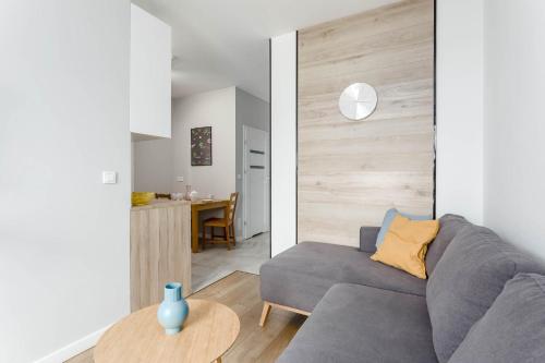 a living room with a couch and a table at Chill Apartments Airport Ursynów in Warsaw
