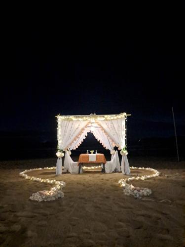 a wedding altar on the beach at night at Nacpan Beach Glamping Managed by H Hospitality Group in El Nido