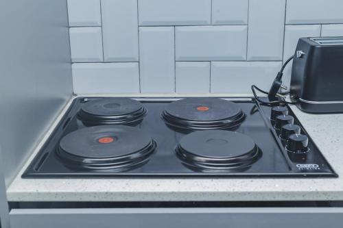 a stove top with four burners on top of it at Oceanic Unit 122 - Durban North Beach in Durban