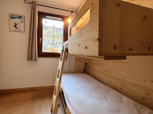 a bunk bed in a room with a window at Appartement Flumet, 2 pièces, 4 personnes - FR-1-505-110 in Flumet