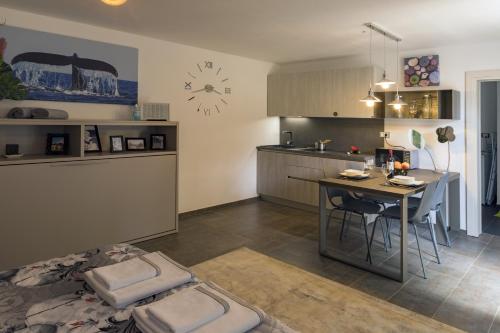 a kitchen with a table and a dining room at Luxury Villa Četiri Hrasta in Pićan