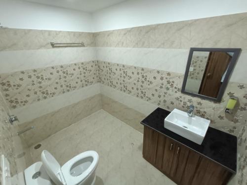 a bathroom with a toilet and a sink at The Cape Grace Hotel in Jalandhar