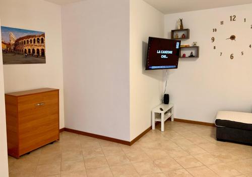 uma sala de estar com uma televisão na parede em Top Apartment 2 em Castel d'Azzano