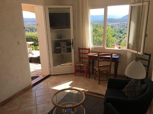 a living room with a view of a table and chairs at Experience the Provençal dream in Taradeau