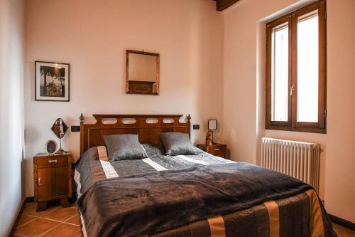 a bedroom with a large bed and a window at La Casa di Clelia in Brisighella