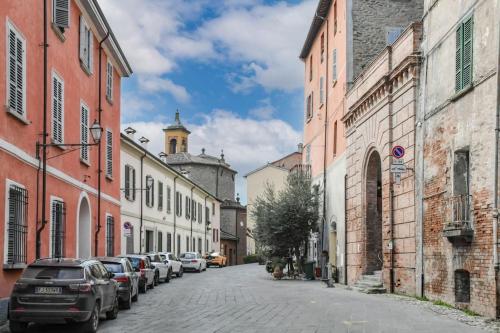 a street with cars parked on the side of a building at La Casa di Clelia in Brisighella