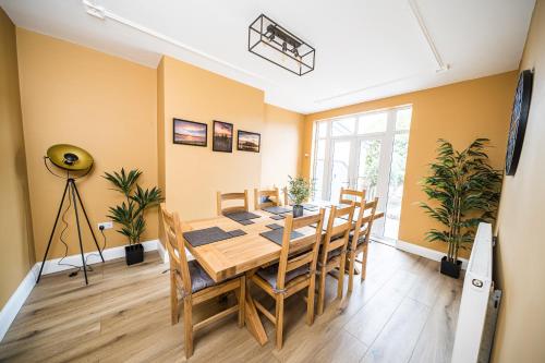 a dining room with a table and chairs at Highgate Beach House in Cleethorpes