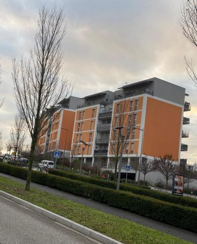 un grand bâtiment au bord d'une rue dans l'établissement La Petite Escapade, à Seynod