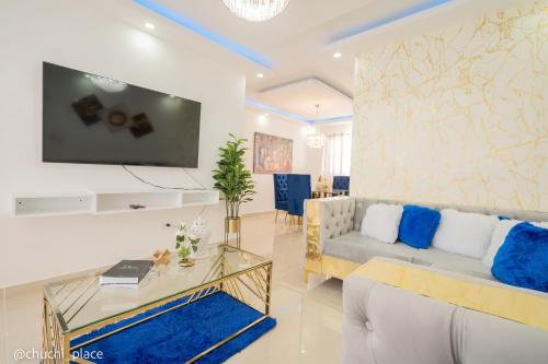 a living room with a couch and a table at Chuchi Place in Santiago de los Caballeros
