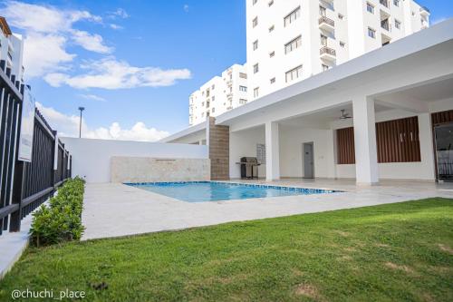a swimming pool in the courtyard of a building at Chuchi Place in Santiago de los Caballeros