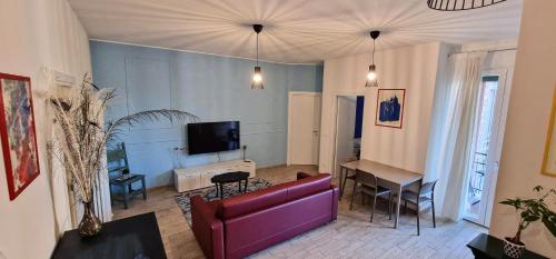 a living room with a red couch and a table at Central City Rooms m09 Apartment in Bologna