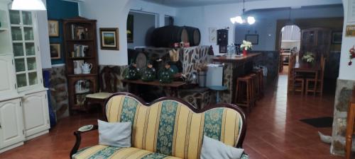 a living room with a couch and a kitchen at Finca Rural La Casa Verde Shalom Tenerife in Las Lagunas