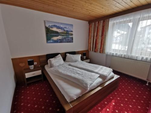a bedroom with a bed and a window at Haus Martha in Kaunertal