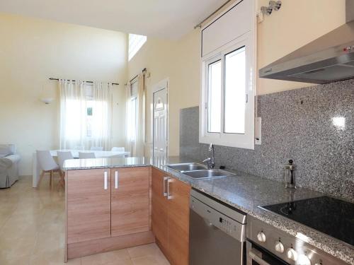 a kitchen with a sink and a counter top at Villa Martina 4 bedroom villa with air conditioning & private swimming pool ideal for families in L'Ametlla de Mar